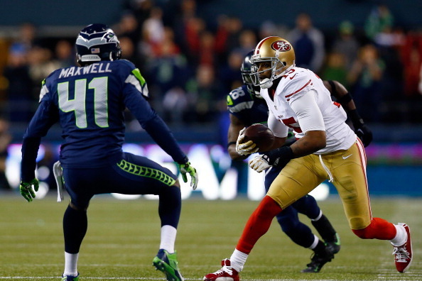 SEATTLE, WA - JANUARY 19: Wide receiver Michael Crabtree #15 of the San Francisco 49ers runs with the ball as cornerback Byron Maxwell #41 of the Seattle Seahawks defends during the 2014 NFC Championship at CenturyLink Field on January 19, 2014 in Seattle