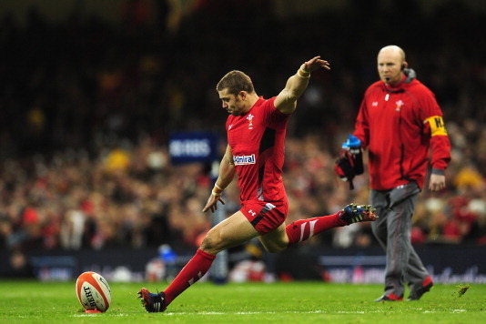 CARDIFF, WALES - FEBRUARY 01:  Wales player Leigh Halfpenny kicks at goal watched by coach Neil Jenkins during the RBS Six Nations match between Wales and Italy at the Millennium stadium on February 1, 2014 in Cardiff, Wales.  (Photo by Stu Forster/Getty 