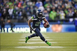 Jan 11, 2014; Seattle, WA, USA; Seattle Seahawks running back Marshawn Lynch (24) carries the ball against the New Orleans Saints during the second half of the 2013 NFC divisional playoff football game at CenturyLink Field. Seattle defeated New Orleans 23
