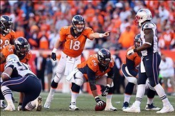 Jan 19, 2014; Denver, CO, USA; Denver Broncos quarterback Peyton Manning (18) signals at the line of scrimmage in the second half against the New England Patriots during the 2013 AFC championship playoff football game at Sports Authority Field at Mile Hig