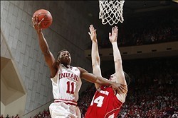 Jan 14, 2014; Bloomington, IN, USA; Indiana Hoosiers guard Yogi Ferrell (11) shoots a basket against Wisconsin Badgers forward Frank Kaminsky (44) at Assembly Hall. Mandatory Credit: Brian Spurlock-USA TODAY Sports