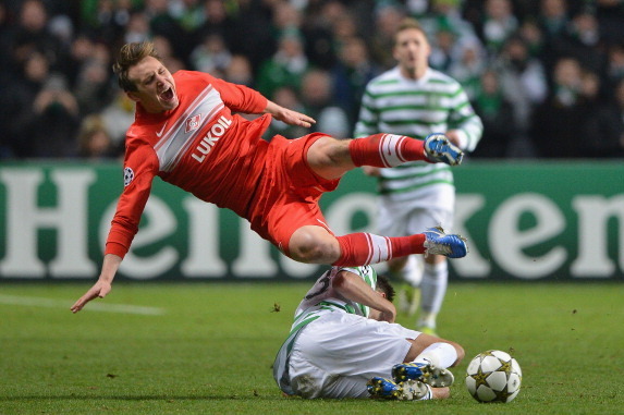 GLASGOW, SCOTLAND - DECEMBER 05:  Mikeal Lustig of Celtic is tackled by Kim Kallstrom of FC Spartak Moscow during the UEFA Champions League Group G match between Celtic and FC Spartak Moscow at Celtic Park on December 5, 2012 in Glasgow, Scotland.  (Photo