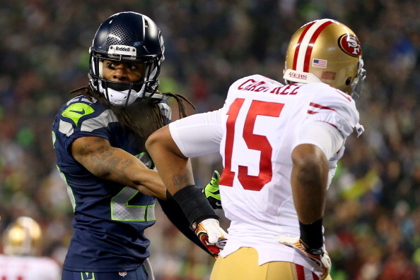 SEATTLE, WA - JANUARY 19:  Cornerback Richard Sherman #25 of the Seattle Seahawks talks with the referee after being called for an unsportsmanlike penalty for taunting wide receiver Michael Crabtree #15 of the San Francisco 49ers late in the fourth quarte