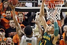 Feb 1, 2014; Stillwater, OK, USA;  Oklahoma State Cowboys forward Le'Bryan Nash (2) drives on Baylor Bears center Isaiah Austin (21) in the fist half at Gallagher-Iba Arena. Mandatory Credit: Tim Heitman-USA TODAY Sports