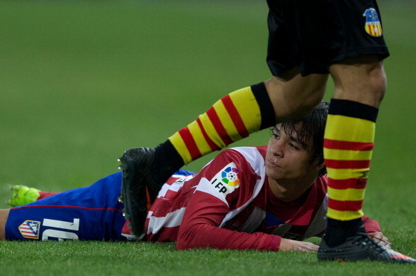 MADRID, SPAIN - DECEMBER 18: Oliver Torres of Atletico de Madrid looks on lied on the ground after being tackled during the Copa del Rey Round of 32 second leg match between Club Atletico de Madrid and Sant Andreu at Vivente Calderon Stadium on December 1