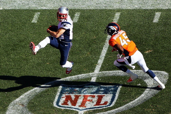 DENVER, CO - JANUARY 19:   Julian Edelman #11 of the New England Patriots completes a reception as  Dominique Rodgers-Cromartie #45 of the Denver Broncos defends in the first half during the AFC Championship game at Sports Authority Field at Mile High on 