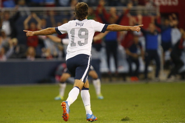 KANSAS CITY, KS - OCTOBER 11:  Graham Zusi #19 of the U.S. Men's National Soccer Team celebrates after scoring the first goal of the game against Jamaica midway in the second half at Sporting Park on October 11, 2013 in Kansas City, Kansas.  (Photo by Kyl