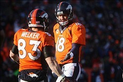 Dec 8, 2013; Denver, CO, USA; Denver Broncos wide receiver Wes Welker (83) is greeted by quarterback Peyton Manning (18) after scoring a touchdown during the first half against the Tennessee Titans at Sports Authority Field at Mile High. The Broncos won 5