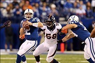 Oct 20, 2013; Indianapolis, IN, USA; Indianapolis Colts quarterback Andrew Luck (12) is pressured by Denver Broncos outside linebacker Von Miller (58) during the first half at Lucas Oil Stadium. Mandatory Credit: Brian Spurlock-USA TODAY Sports