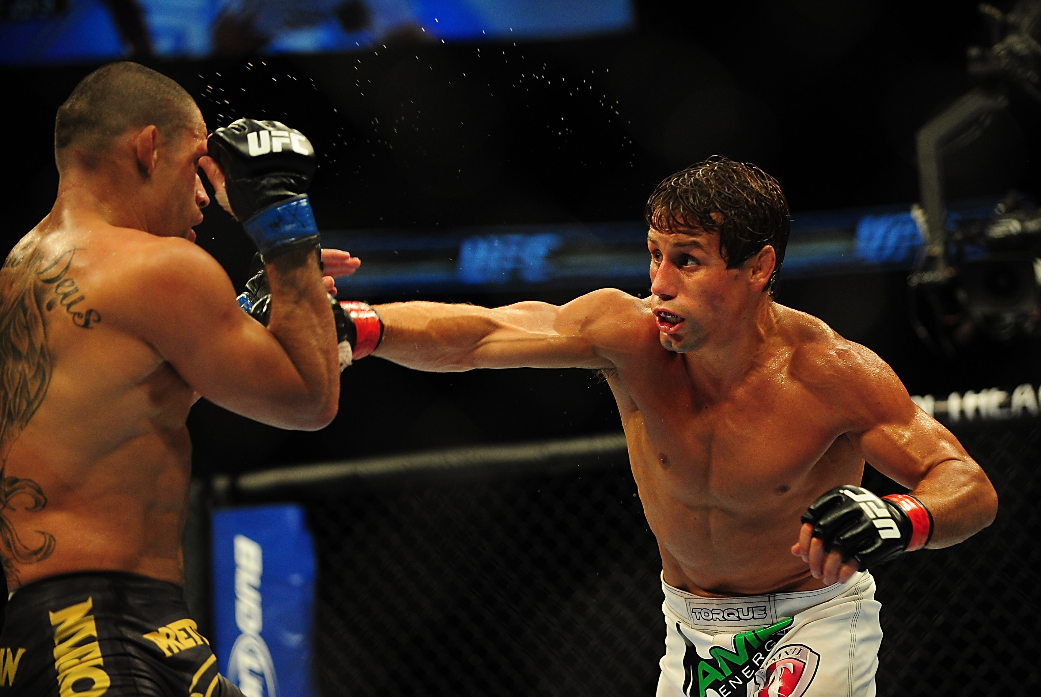 Jul 21, 2012; Calgary, AB, CANADA; Renan Barao (blue golves) and Urijah Faber (red gloves) during the interim bantamweight title bout of UFC 149 at the Scotiabank Saddledome. Mandatory Credit: Anne-Marie Sorvin-USA TODAY Sports