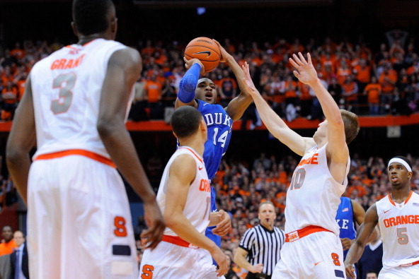 SYRACUSE, NY - FEBRUARY 01:  Rasheed Sulaimon #14 of the Duke Blue Devils takes a shot over Trevor Cooney #10 of the Syracuse Orange during the second half at the Carrier Dome on February 1, 2014 in Syracuse, New York. Syracuse defeated Duke 91-89 in over