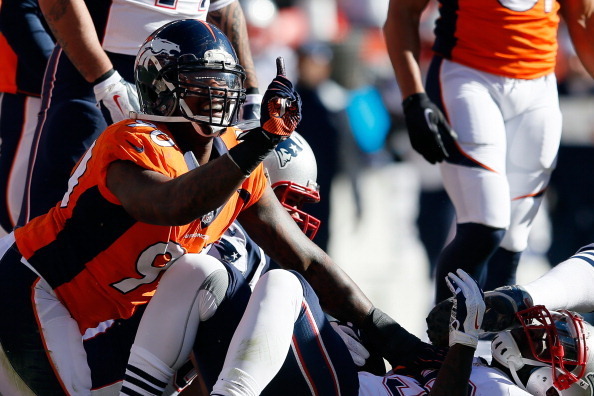 DENVER, CO - JANUARY 19:   Shaun Phillips #90 of the Denver Broncos reacts to a defensive stop on  LeGarrette Blount #29 of the New England Patriots during the AFC Championship game at Sports Authority Field at Mile High on January 19, 2014 in Denver, Col