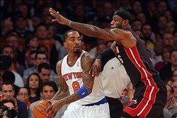 Feb 1, 2014; New York, NY, USA; New York Knicks shooting guard J.R. Smith (8) is defended by Miami Heat small forward LeBron James (6) during the first period of a game at Madison Square Garden. Mandatory Credit: Brad Penner-USA TODAY Sports