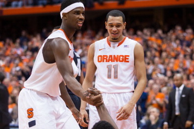 SYRACUSE, NY - DECEMBER 28:  C.J. Fair #5 of the Syracuse Orange helps up teammate Jerami Grant #3 as Tyler Ennis #11 laughs following a second half foul against Villanova Wildcats on December 28, 2013 at The Carrier Dome in Syracuse, New York.  (Photo by