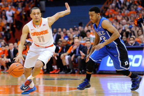 SYRACUSE, NY - FEBRUARY 01:  Tyler Ennis #11 of the Syracuse Orange dribbles the ball up the court past Quinn Cook #2 of the Duke Blue Devils during the first half at the Carrier Dome on February 1, 2014 in Syracuse, New York.  Syracuse defeated Duke 91-8