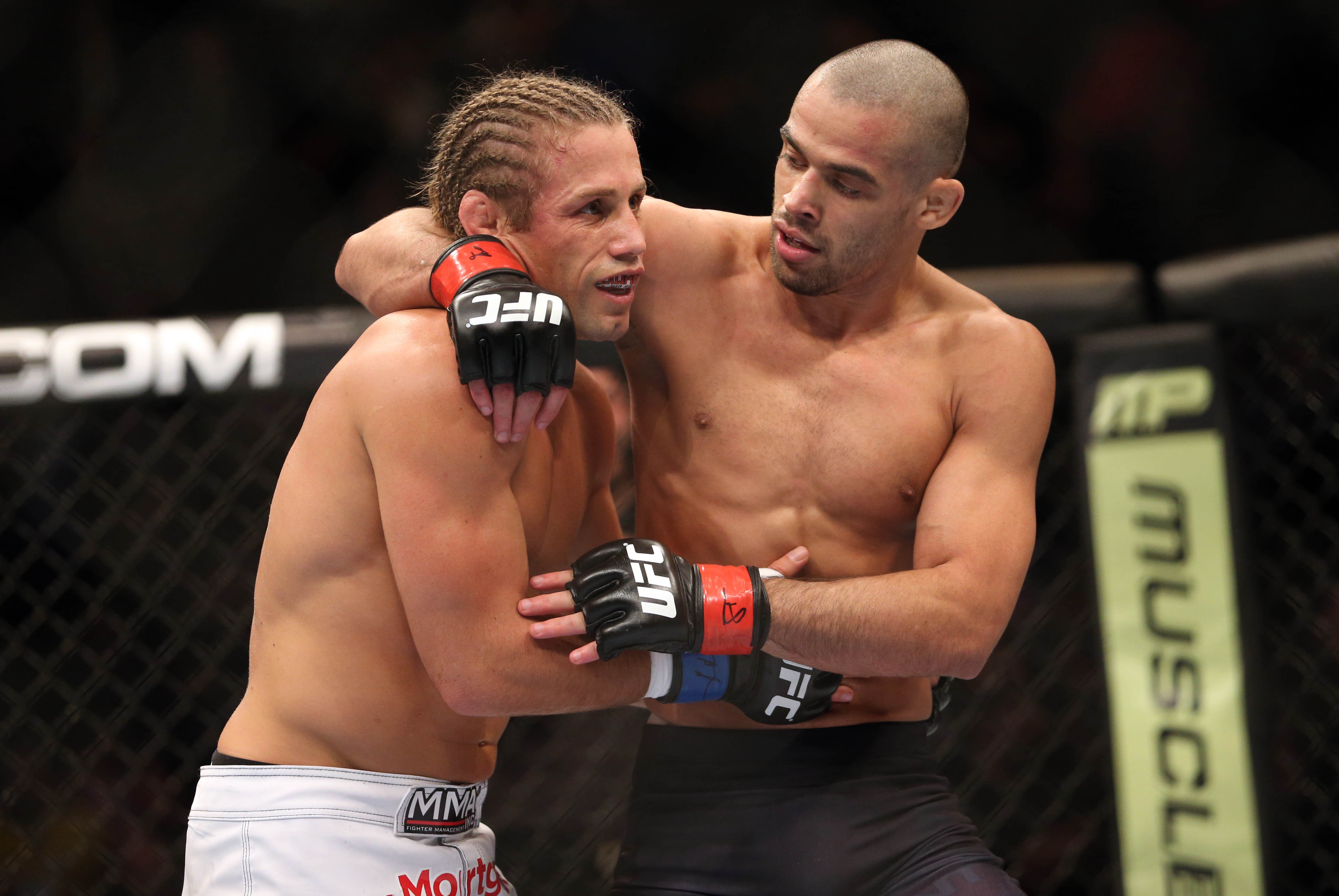 Feb 1, 2014; Newark, NJ, USA; Renan Barao (red gloves) and Urijah Faber (blue gloves) after their fight during UFC 169 at Prudential Center. Mandatory Credit: Joe Camporeale-USA TODAY Sports