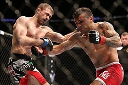 Feb 1, 2014; Newark, NJ, USA; John Lineker (red gloves) fights Ali Bagautinov (blue gloves) during UFC169 at Prudential Center. Mandatory Credit: Joe Camporeale-USA TODAY Sports