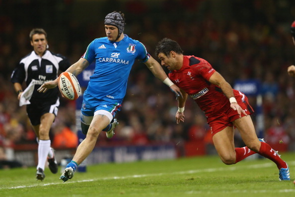 CARDIFF, WALES - FEBRUARY 01:  Michele Campagnaro of Italy kicks ahead as Mike Phillips of Wales challenges during the RBS Six Nations match between Wales and Italy at the Millenium Stadium on February 1, 2014 in Cardiff, Wales.  (Photo by Michael Steele/