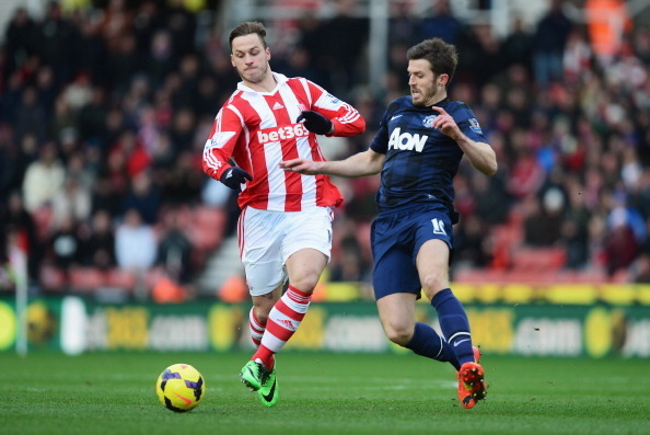 STOKE ON TRENT, ENGLAND - FEBRUARY 01: Marko Arnautovic of Stoke City is closed down by Michael Carrick of Manchester United during the Barclays Premier League match between Stoke City and Manchester United at Britannia Stadium on February 1, 2014 in Stok