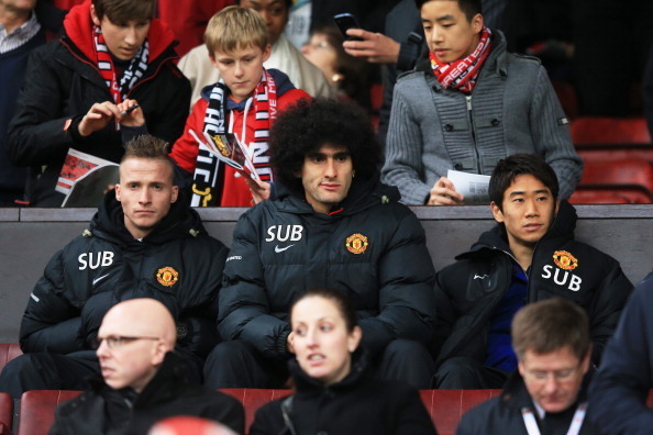 MANCHESTER, ENGLAND - DECEMBER 07:  (L-R) Unused squad mambers Alexander Buettner, Marouane Fellaini  and Shinji Kagawa of Manchester United look on during the Barclays Premier League match between Manchester United and Newcastle United at Old Trafford on