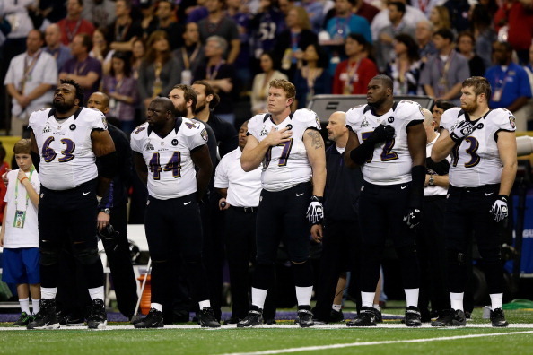 NEW ORLEANS, LA - FEBRUARY 03:  (L-R) Bobbie Williams #63, Vonta Leach #44, Matt Birk #77, Kelechi Osemele #72 and Marshal Yanda #73 of the Baltimore Ravens stand for the performance of the National Anthem against the San Francisco 49ers  during Super Bow