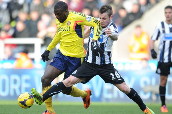 NEWCASTLE UPON TYNE, ENGLAND - FEBRUARY 01:  Jozy Altidore of Sunderland is challenged by Mathieu Debuchy of Newcastle during the Barclays Premier League match between Newcastle United and Sunderland at St James' Park on February 1, 2014 in Newcastle upon
