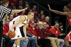 Feb 1, 2014; Madison, WI, USA; Wisconsin Badgers guard Ben Brust (1) looks to pass as Ohio State Buckeyes forward Sam Thompson (12) defends during the first half at the Kohl Center. Mandatory Credit: Mary Langenfeld-USA TODAY Sports