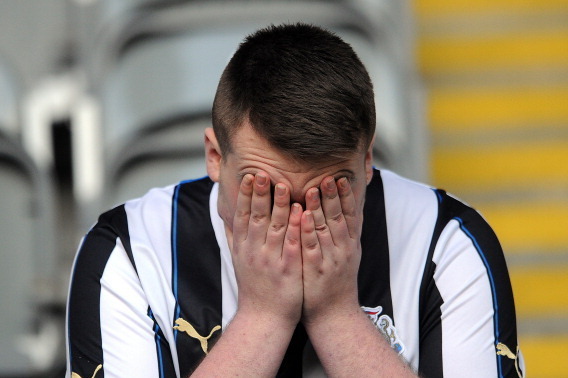 NEWCASTLE UPON TYNE, ENGLAND - FEBRUARY 01: A Newcastle United fan looks dejected following the Barclays Premier League match between Newcastle United and Sunderland at St James' Park on February 01, 2014 in Newcastle upon Tyne, England. (Photo by Chris B