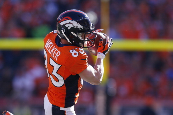 DENVER, CO - JANUARY 19:   Wes Welker #83 of the Denver Broncos completes a reception in the first quarter against the New England Patriots during the AFC Championship game at Sports Authority Field at Mile High on January 19, 2014 in Denver, Colorado.  (