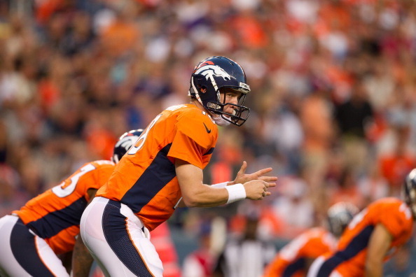 DENVER, CO - AUGUST 18:  Quarterback Peyton Manning #18 of the Denver Broncos signals against the Seattle Seahawks at Sports Authority Field Field at Mile High on August 18, 2012 in Denver, Colorado. (Photo by Justin Edmonds/Getty Images)