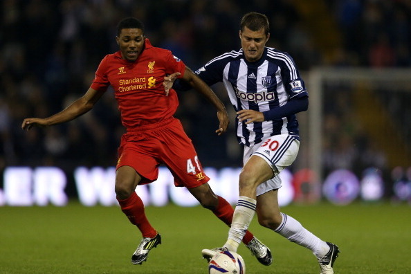 WEST BROMWICH, ENGLAND - SEPTEMBER 26:  Jerome Sinclair of Liverpool battles with Gabriel Tamas of West Brom during the Capital One Cup third round match between West Bromwich Albion and Liverpool at The Hawthorns on September 26, 2012 in West Bromwich, E
