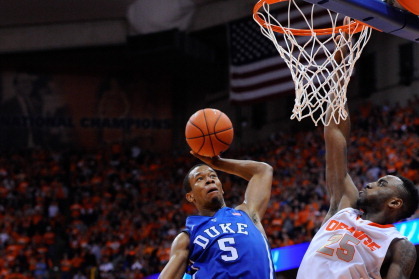 SYRACUSE, NY - FEBRUARY 01:  Rodney Hood #5 of the Duke Blue Devils goes up for a shot between C.J. Fair #5 (L) and Rakeem Christmas #25 of the Syracuse Orange during overtime at the Carrier Dome on February 1, 2014 in Syracuse, New York.  Syracuse defeat