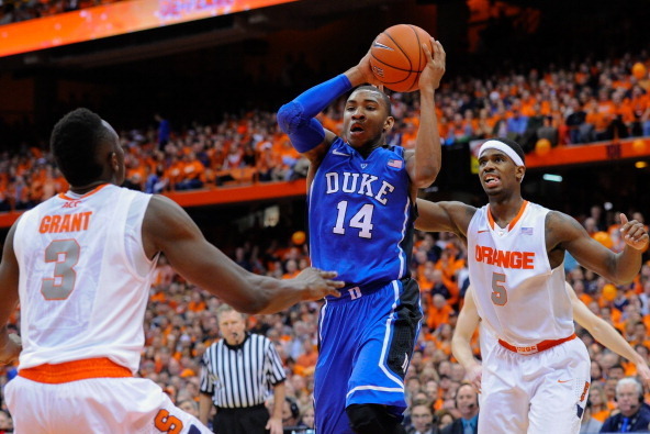 SYRACUSE, NY - FEBRUARY 01:  Rasheed Sulaimon #14 of the Duke Blue Devils drives to the basket between Jerami Grant #3 and C.J. Fair #5 of the Syracuse Orange during the second half at the Carrier Dome on February 1, 2014 in Syracuse, New York.  Syracuse 