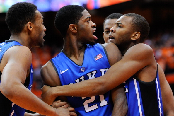 SYRACUSE, NY - FEBRUARY 01:  (L-R) Jabari Parker #1, Amile Jefferson #21 and Rasheed Sulaimon #14 of the Duke Blue Devils celebrate a basket and a foul against the Syracuse Orange during the second half at the Carrier Dome on February 1, 2014 in Syracuse,