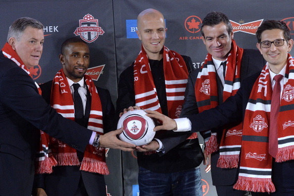 TORONTO, ON - JANUARY 13: (L-R) MLSE President Tim leiweki, Jermain Defoe, Michael Bradley, Head Coach Ryan Nelson and Toronto FC General Manager Tim Bezbatchenko pose at a Toronto FC press conference introducing the signing of  Michael Bradley and Jermai