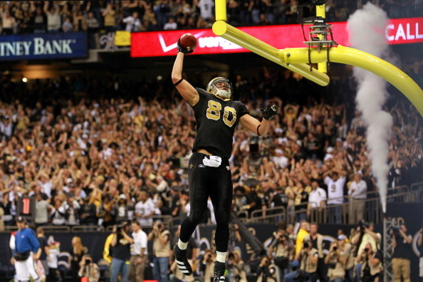 NEW ORLEANS, LA - JANUARY 07:   Jimmy Graham #80 of the New Orleans Saints celebrates by dunking the football over the crossbar after scoring a touchdown in the third quarter against the Detroit Lions during their 2012 NFC Wild Card Playoff game at Merced