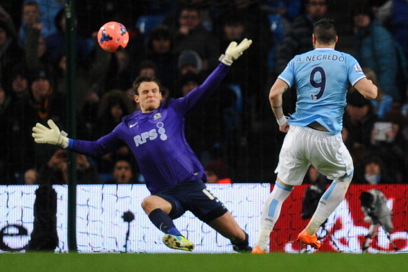MANCHESTER, ENGLAND - JANUARY 15:  Alvaro Negredo of Manchester City scores the second goal past Simon Eastwood of Blackburn Rovers during the Budweiser FA Cup Third Round Replay match between Manchester City and Blackburn Rovers at the Etihad Stadium on 