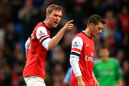 MANCHESTER, ENGLAND - DECEMBER 14:  Per Mertesacker of Arsenal has words with Mesut Oezil of Arsenal during the Barclays Premier League match between Manchester City and Arsenal at Etihad Stadium on December 14, 2013 in Manchester, England.  (Photo by Ric