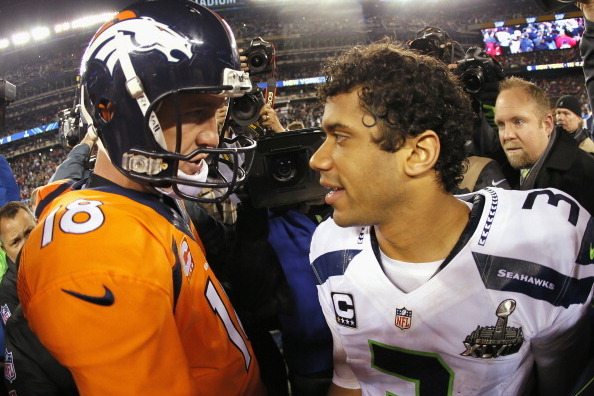 EAST RUTHERFORD, NJ - FEBRUARY 02:  (L-R) Quarterback Peyton Manning #18 of the Denver Broncos congratulates quarterback Russell Wilson #3 of the Seattle Seahawks on their 43-8 win during Super Bowl XLVIII at MetLife Stadium on February 2, 2014 in East Ru