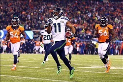 Feb 2, 2014; East Rutherford, NJ, USA; Seattle Seahawks wide receiver Percy Harvin (11) returns a kick for a touchdown against the Denver Broncos in the third quarter in Super Bowl XLVIII at MetLife Stadium.  Mandatory Credit: Mark J. Rebilas-USA TODAY Sp