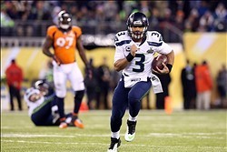 Feb 2, 2014; East Rutherford, NJ, USA; Seattle Seahawks quarterback Russell Wilson (3) runs against the Denver Broncos during the fourth quarter in Super Bowl XLVIII at MetLife Stadium.  Mandatory Credit: Matthew Emmons-USA TODAY Sports