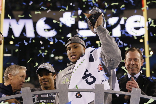 EAST RUTHERFORD, NJ - FEBRUARY 02:  MVP Malcolm Smith #53 of the Seattle Seahawks celebrates with the Vince Lombardi Trophy after their 43-8 victory over the Denver Broncos during Super Bowl XLVIII at MetLife Stadium on February 2, 2014 in East Rutherford