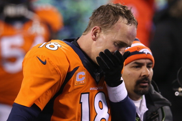 EAST RUTHERFORD, NJ - FEBRUARY 02:  Quarterback Peyton Manning #18 of the Denver Broncos walks off the field after their 43-8 loss to the Seattle Seahawks during Super Bowl XLVIII at MetLife Stadium on February 2, 2014 in East Rutherford, New Jersey.  (Ph