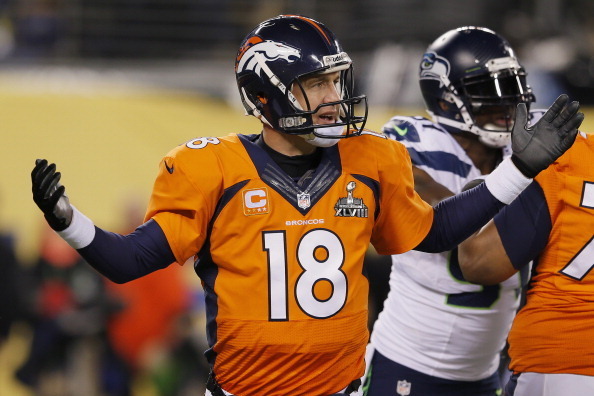 EAST RUTHERFORD, NJ - FEBRUARY 02:  Quarterback Peyton Manning #18 of the Denver Broncos reacts in the fourth quarter while taking on the Seattle Seahawks during Super Bowl XLVIII at MetLife Stadium on February 2, 2014 in East Rutherford, New Jersey.  (Ph