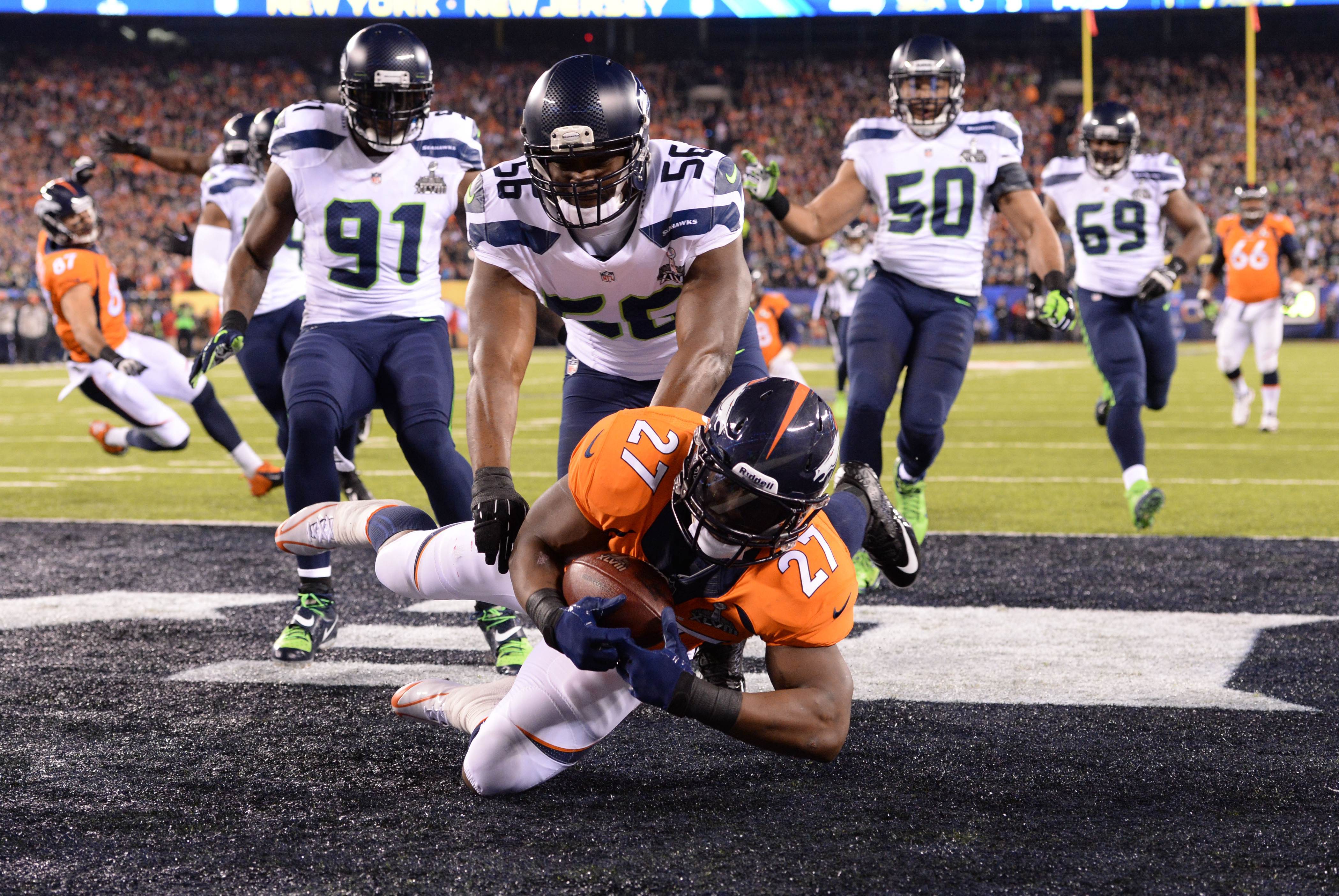 Feb 2, 2014; East Rutherford, NJ, USA; Denver Broncos running back Knowshon Moreno (27) recovers a fumble in the end zone against the Seattle Seahawks for a safety in the first quarter in Super Bowl XLVIII at MetLife Stadium.  Mandatory Credit: Robert Deu
