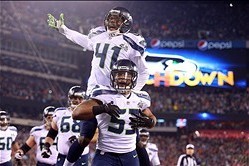 Feb 2, 2014; East Rutherford, NJ, USA; Seattle Seahawks outside linebacker Malcolm Smith (53) and cornerback Byron Maxwell (41) celebrate a touchdown during the first half against the Denver Broncos in Super Bowl XLVIII at MetLife Stadium.  Mandatory Cred