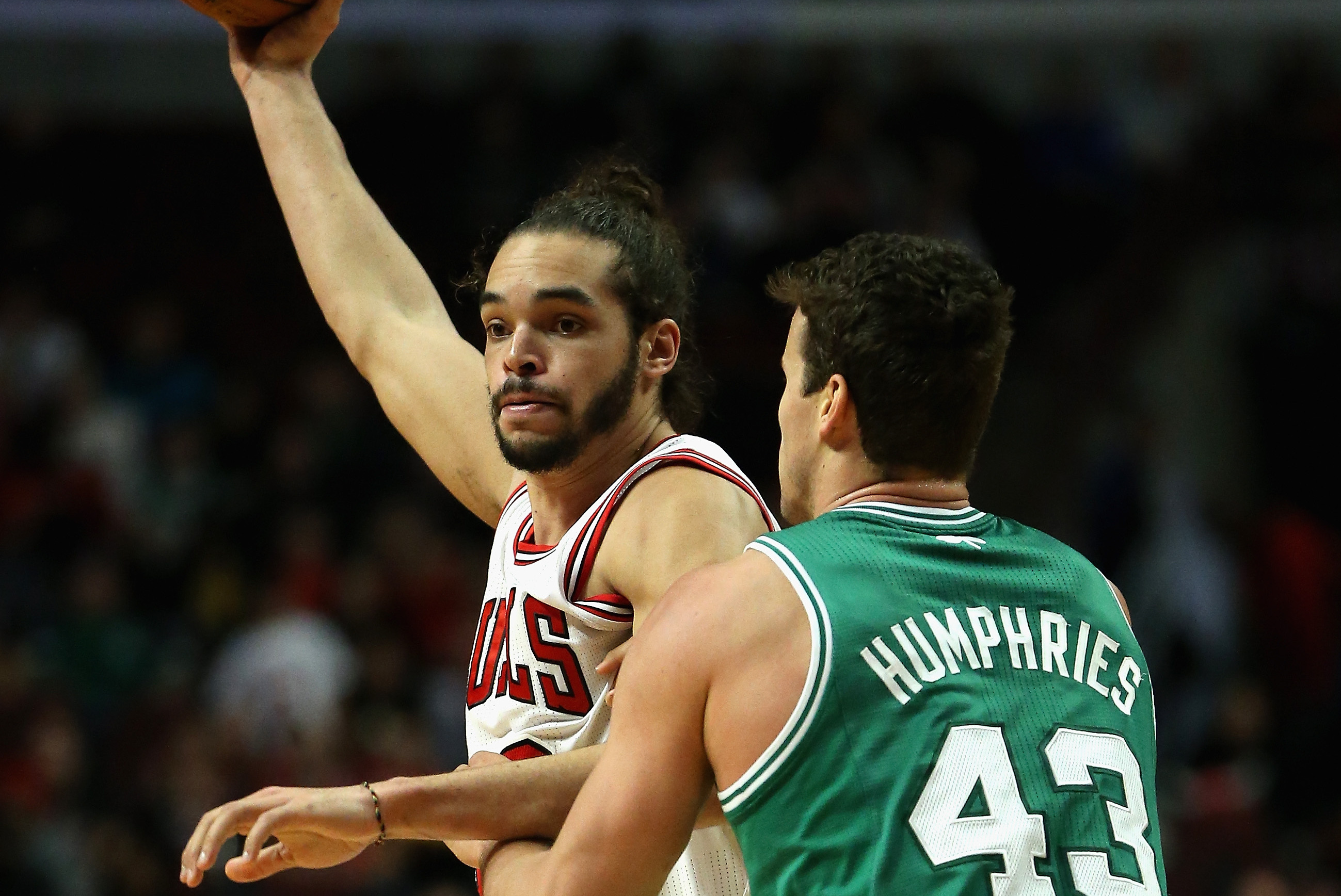 CHICAGO, IL - JANUARY 02: Joakim Noah #13 of the Chicago Bulls looks to pass under pressure from Kris Humpries #43 of the Boston Celtics at the United Center on January 2, 2014 in Chicago, Illinois. The Bulls defeated the Celtics 94-82. NOTE TO USER: User