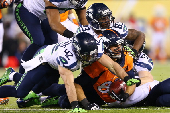 EAST RUTHERFORD, NJ - FEBRUARY 02: Wide receiver Eric Decker #87 of the Denver Broncos is tackled  during Super Bowl XLVIII at MetLife Stadium on February 2, 2014 in East Rutherford, New Jersey.  (Photo by Elsa/Getty Images)
