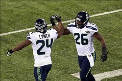 Feb 2, 2014; East Rutherford, NJ, USA; Seattle Seahawks running back Marshawn Lynch (24) celebrates his touchdown with fullback Michael Robinson (26) against the Denver Broncos during the second quarter in Super Bowl XLVIII at MetLife Stadium.  Mandatory 