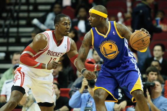 HOUSTON, TX - DECEMBER 06:  Jermaine O'Neal #7 of the Golden State Warriors drives against Dwight Howard #12 of the Houston Rockets during the game at Toyota Center on December 6, 2013 in Houston, Texas. NOTE TO USER: User expressly acknowledges and agree